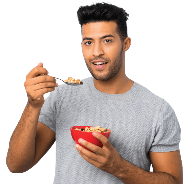 A man with a spoon in hand, relishing a bowl of cereal