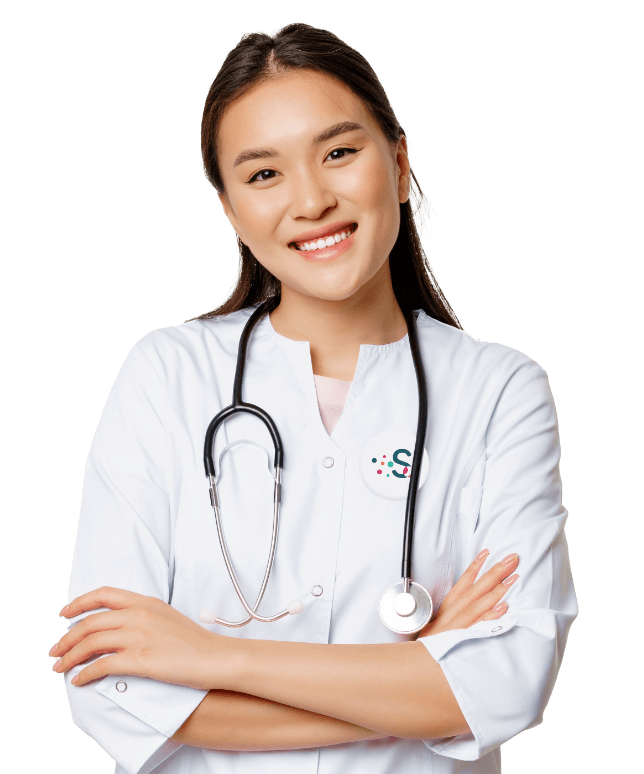 A female doctor smiles confidently with her arms crossed, exuding professionalism and warmth in her demeanor